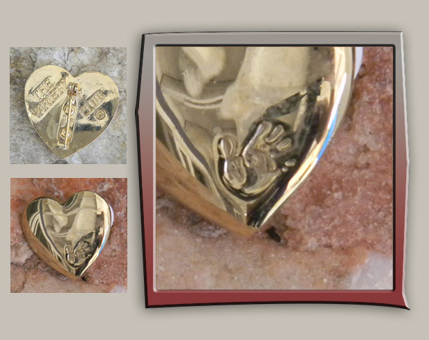 Simple gold heart brooch with hand impression on front and designer stamp on back