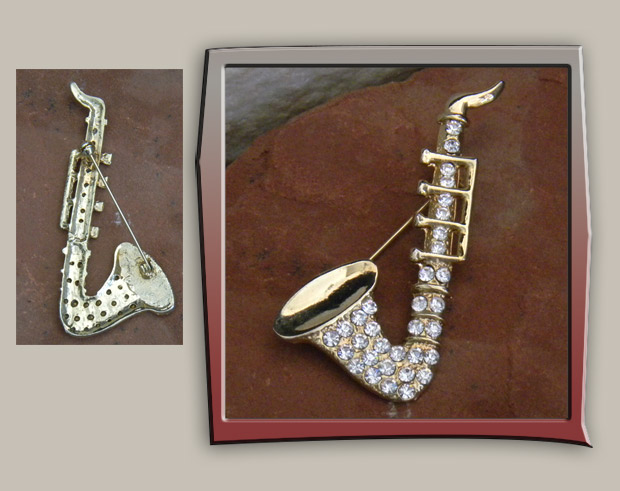 Vintage brooch of saxophone with gold metal and rhinestones