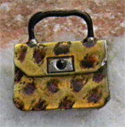 Cute yet sturdy amber purse brooch has leopard skin look with enamel technique.