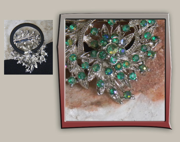 This brooch is a leaf spray covered with sparkling teal crystals