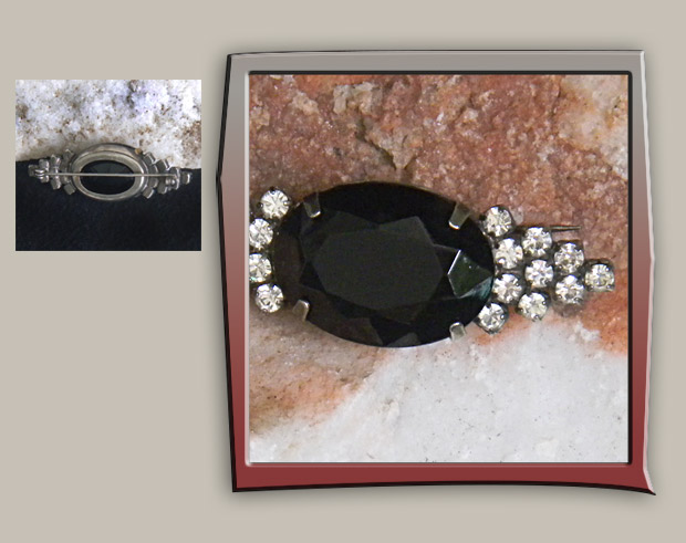 Simple and elegant brooch has black glass faceted in oval shape decorated with rhinestones