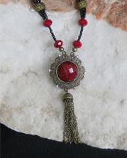 designer beaded necklace with deep red beveled glass Victorian style pendant matches faceted stones. 