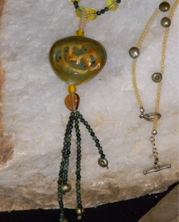 designer necklace with olive ceramic pendant