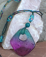 designer necklace with pink and teal resin pendant