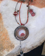 designer metal pendant with charming embellishments