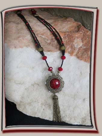 Triple strand of black and red seed beads give this necklace a lovely layered, lacy look