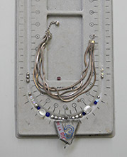bead layout with glass chard steampunk pendant